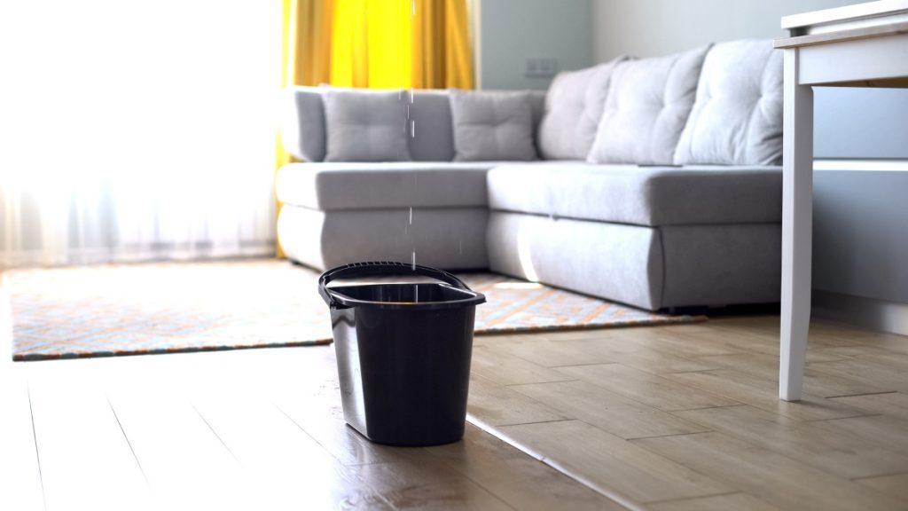 Condo water damage leaking into a bucket