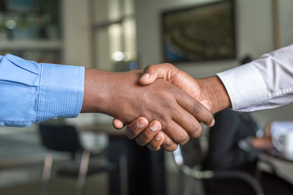 Handshake image that demonstrates Merlin Law Group's practice of No Fee Unless We Win