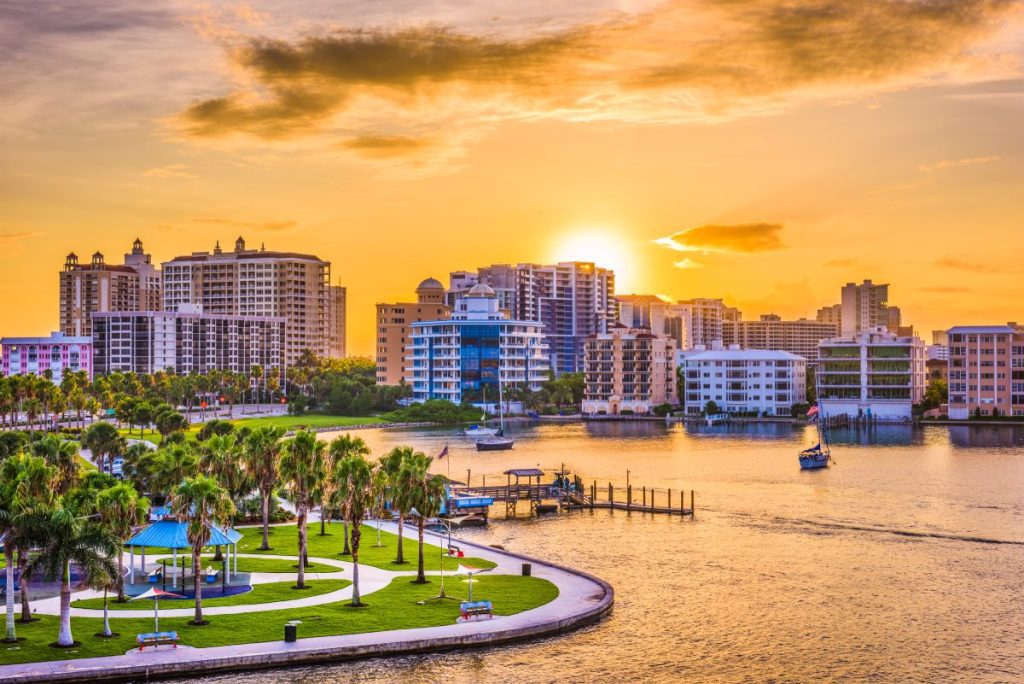 Waterfront condominiums and high-rise buildings in Florida at sunset, representing real estate protection needing to be covered by property and casualty insurance.